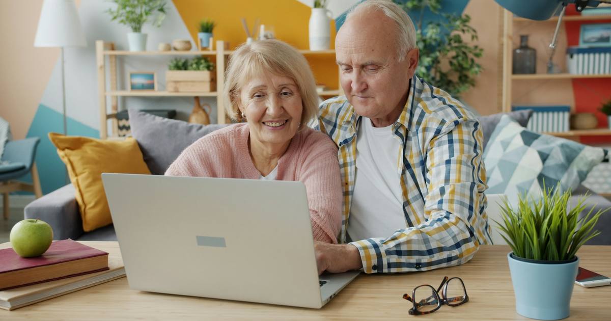 A couple comparing loan options on a laptop at home
